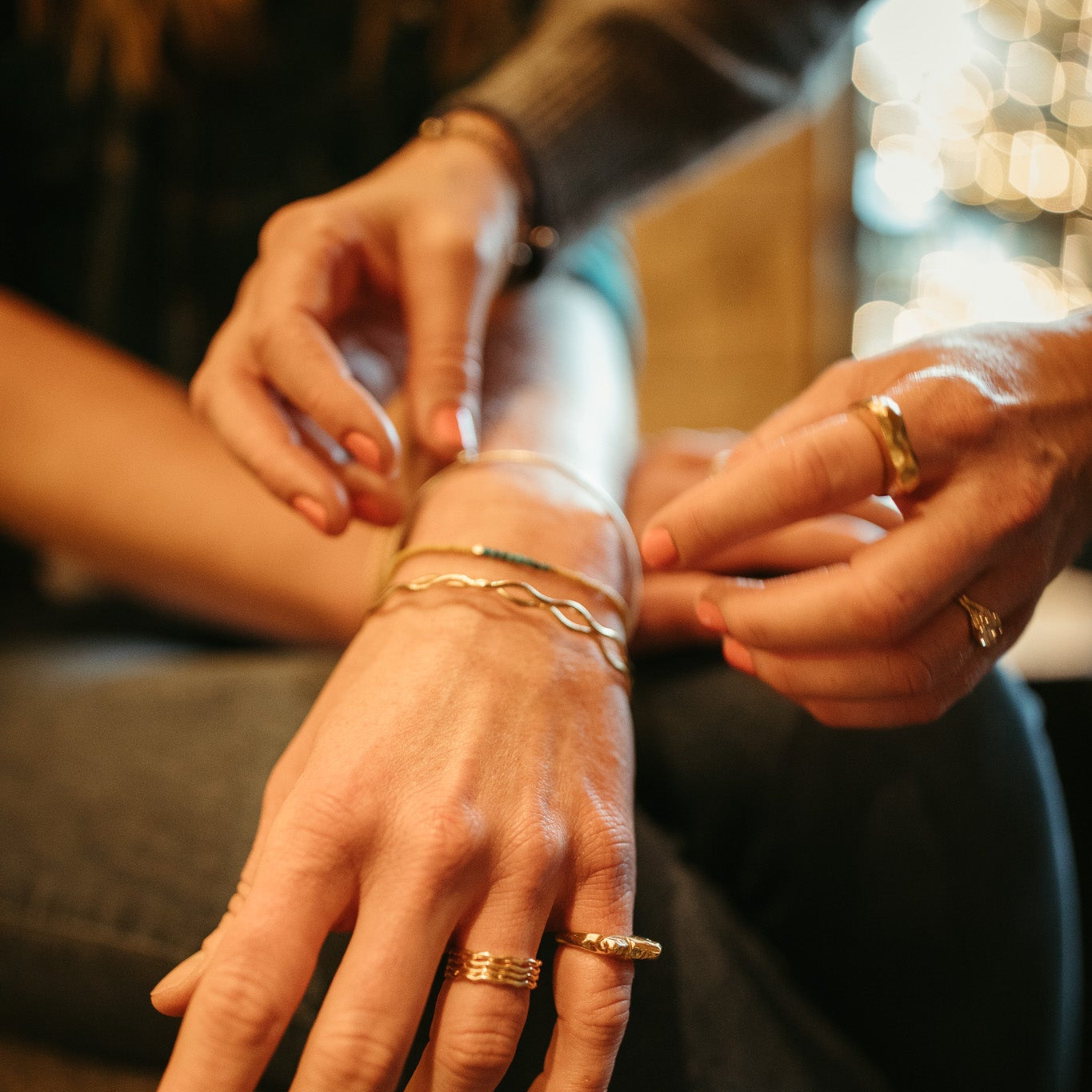 Close-up of hands with jewelry on a blurred background
