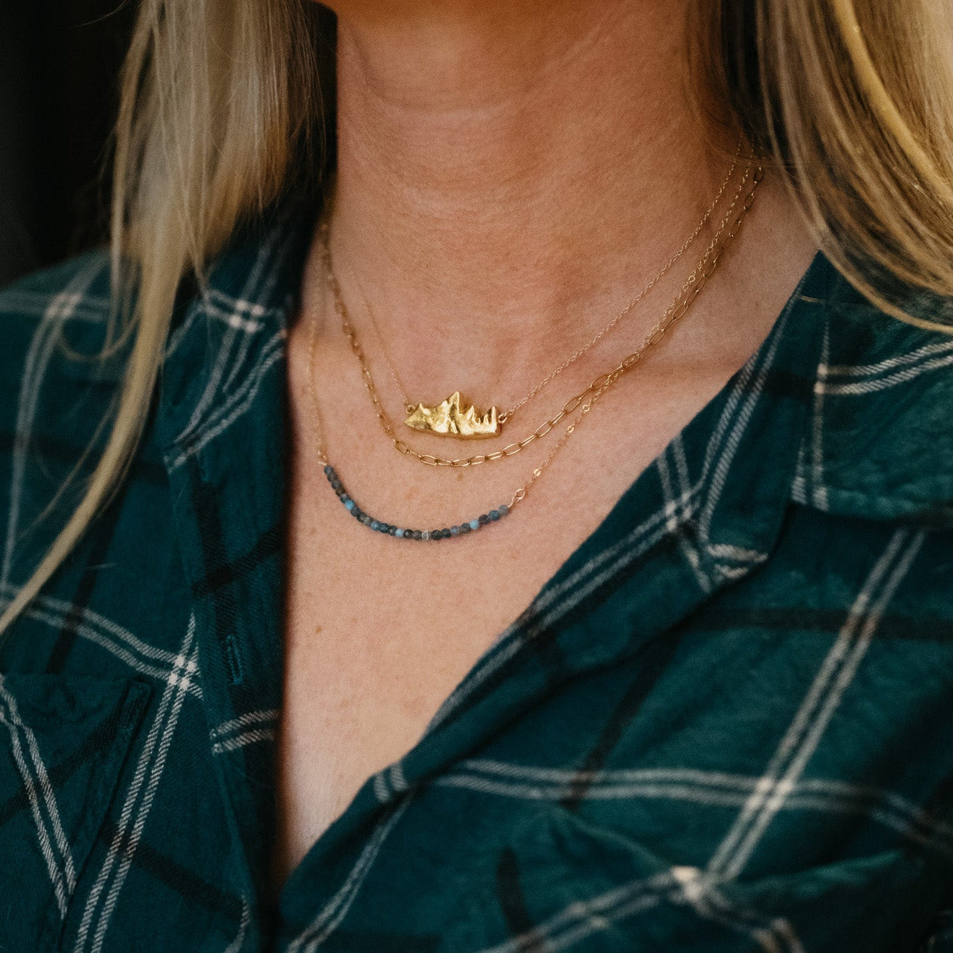 Handcrafted Teton I mountain pendant necklace in gold vermeil on model