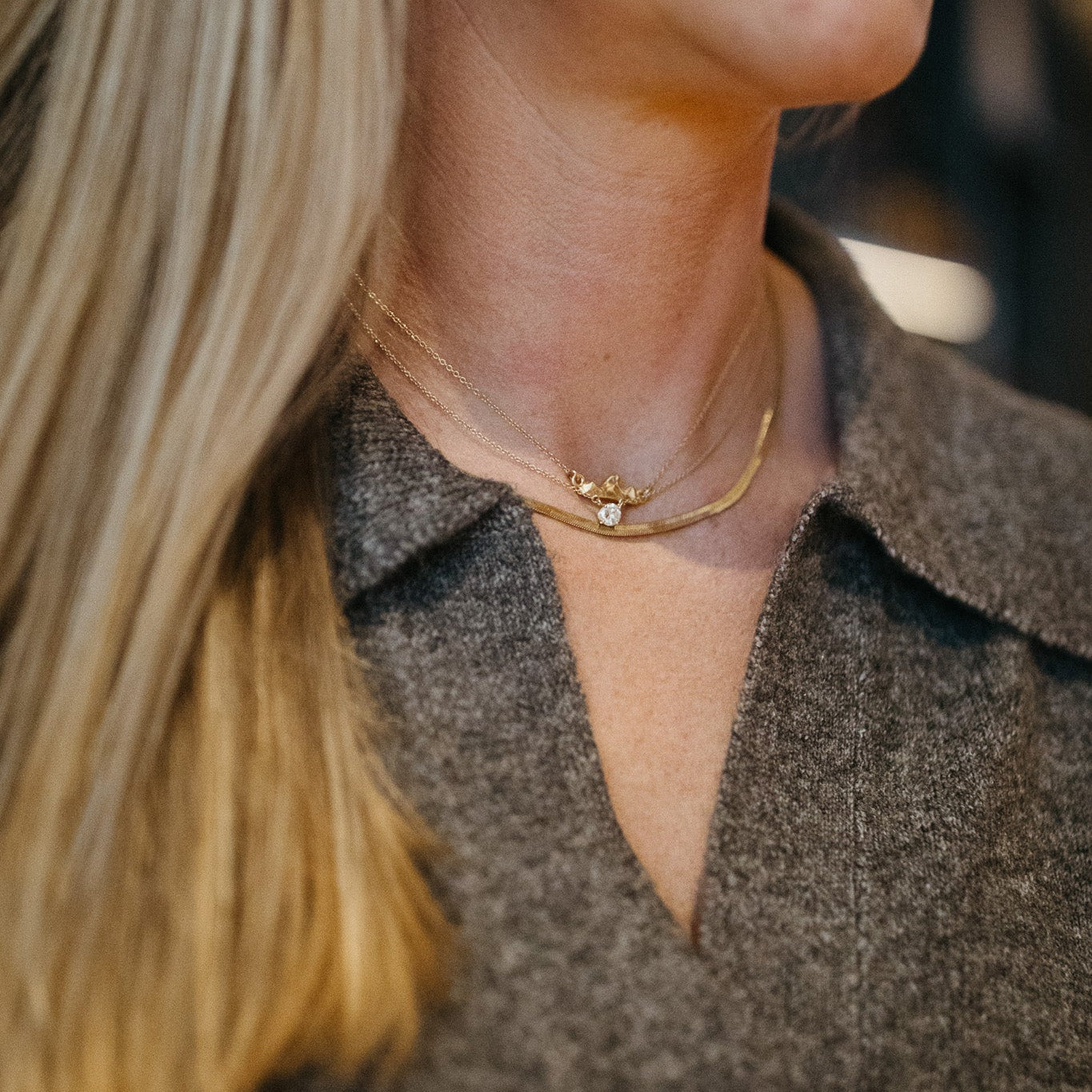 Teton III small mountain pendant necklace in gold vermeil on model layered with other necklaces