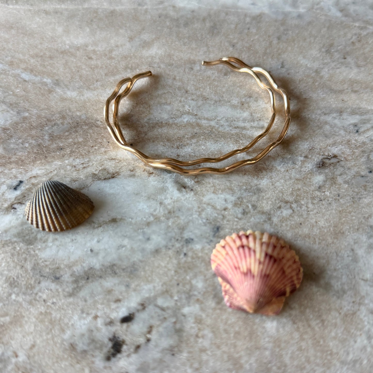 Close-up of 14/20 gold fill wave cuff showing hand-sculpted ocean wave texture and high polish finish