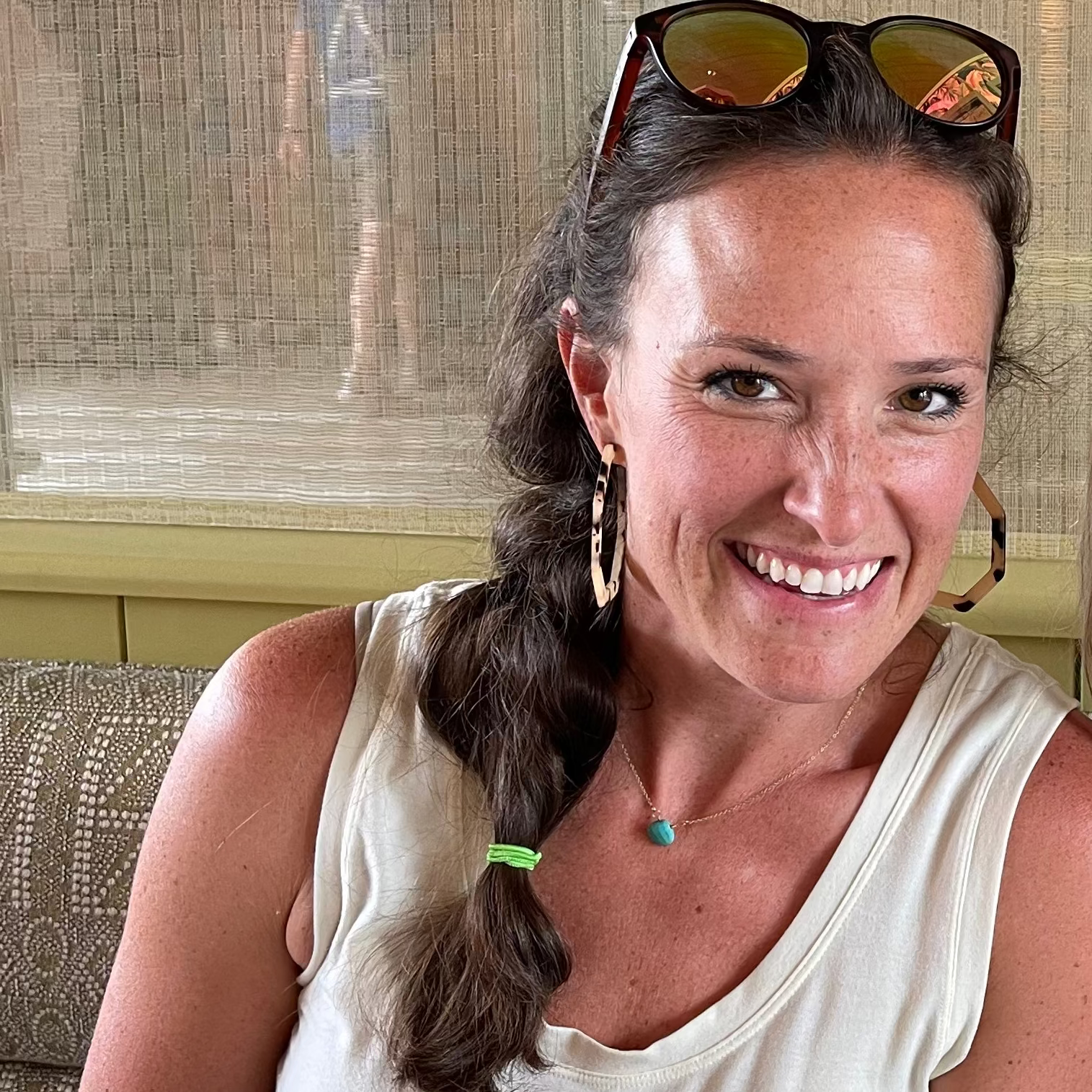Woman wearing a delicate turquoise briolette necklace on a 15-inch gold-filled chain, sitting at collarbone length, perfect for everyday layering and minimalist style.